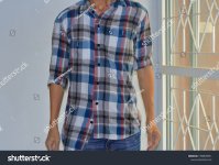 stock-photo-man-wearing-buttoned-wrong-and-rolled-up-sleeves-plaid-shirt-mistake-or-intend-to...jpeg